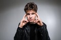 Wide angle. Studio shot. Young caucasian guy model in black clothes posing in the studio. Teenager in Leather Jacket Standing at Royalty Free Stock Photo