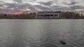 A wide angle sunset shot of the Como lake bandshell calm lake under fall colors 4K timelapse