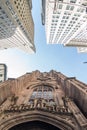 Wide angle upward view of Trinity Church at Broadway and Wall Street with surrounding skyscrapers, Lower Manhattan, New Royalty Free Stock Photo