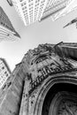 Wide angle upward view of Trinity Church at Broadway and Wall Street with surrounding skyscrapers, Lower Manhattan, New Royalty Free Stock Photo