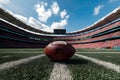 Wide angle view American football stadium with ball on ground photo, portraying sports venue