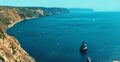 Wide angle view of beautiful landscape with bay of water with high limestone cliff over blue sea and clear deep blue sky Royalty Free Stock Photo