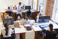 Wide Angle View Of Busy Design Office With Workers At Desks Royalty Free Stock Photo