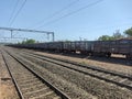 Long Freight Train on Multiple Railway Tracks Under Clear Blue Sky Royalty Free Stock Photo