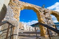 Wide angle view of Cefalu town through stone arch gate, Sicily, Italy