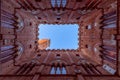 Wide angle view from the courtyard of Palazzo Pubblico to the famous Torre del Mangia. Royalty Free Stock Photo