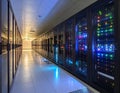 Data center corridor with rows of server cabinets illuminated by blue and green lights server room Royalty Free Stock Photo