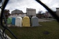 Wide angle view through the fence of Bunch of Trash Containers or dust bins for Garbage placed in the school premises in southern