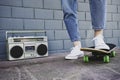 Wide angle view of a guy getting ready to skate down outdoors - Teen or millennial guy having fun skating and listening music Royalty Free Stock Photo