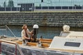 Wide angle view at handsome young man sailing boat on river Royalty Free Stock Photo