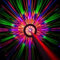 A wide angle view of a laser beam being directed through a lens with an abstract colorful diffraction pattern in the background