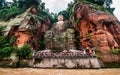 Wide angle view of Leshan Giant Buddha or Dafo from river boat in Leshan China