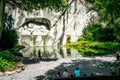 Wide angle view of Lion monument and pool with tourists around it in Lucerne Switzerland