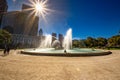 Wide angle view of Logan Square, a traffic circle center with a large fountain with whimsical