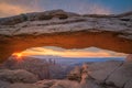 Mesa Arch sunrise and colorful clouds Royalty Free Stock Photo