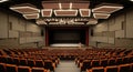 Modern Auditorium Interior with Tiered Seating and Stage Lighting theater Royalty Free Stock Photo