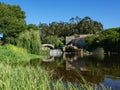 Wide angle view over Este River in Portugal, reeds in foreground with stone ruins and old Roman bridge Royalty Free Stock Photo