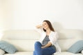 Woman resting in a couch with copy space above