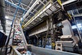 Wide angle view at recycling plant conveyor belt transports garbage inside drum filter or rotating cylindrical sieve with trommel Royalty Free Stock Photo