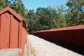 This is a wide angle view of the red wooden footbridge.