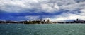 Wide angle view from sea looking into Sydney where cloud and heavy rain settling over city