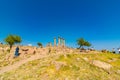 Wide angle view of Temple of Athena in Assos ancient city and tourists