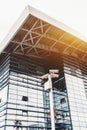 Pillar with security cameras and building of railway station behind Royalty Free Stock Photo