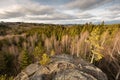 Wide angle view from the top of the rocky mountain with forest on valley and clouds on sky on background Royalty Free Stock Photo