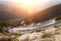 Wide angle view of winding road, laid to the top of the mountain. Sunset shine Royalty Free Stock Photo