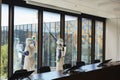 Wide Angle of Workers Disinfecting Windows in Office Royalty Free Stock Photo