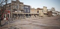 Wide angled view of a rustic antique Western town with various businesses. Royalty Free Stock Photo