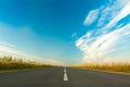 Wide Asphalt Gray Road On Bright Blue Sky Background.