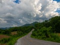 Wide asphalt highway with road markings against a blue sky with clouds Royalty Free Stock Photo