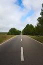 Wide asphalt road vanishing in the horizon in a hilly region of San Luis, Argentina.