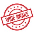 WIDE AWAKE text written on red vintage round stamp Royalty Free Stock Photo