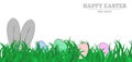 Wide banner with Easter bunny and eggs in green grass on a white background. Classic easter concept - rabbit ears and Royalty Free Stock Photo