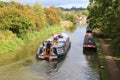 Wide beam narrowboat cruising canal