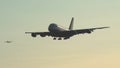 Airplane approaching to landing during sunrise