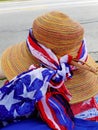 Wide brimmed floppy summer straw hat decorated with a patriotic stars and stripes themed head scarf for 4th of July parade Royalty Free Stock Photo