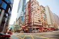 Wide broad street with skyscrapers and fast driving taxi car on city road of Hong Kong