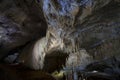 Wide cave chamber with curtain flowstone and delicate stalactites Royalty Free Stock Photo