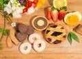 Wide choice of chocolate cookies,shortbread and tart with fruit jam and cocoa cream,strawberries, cinnamon and spring flowers. Royalty Free Stock Photo