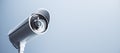 Wide close up image of cctv camera on light blue background with mock up place for your text and advertisement. Control system Royalty Free Stock Photo