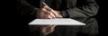 Wide cropped view of a businessman in business suit signing cont