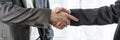 Wide cropped view of two businessmen shaking hands