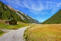 Wide dirt road in an Alpine valley Royalty Free Stock Photo