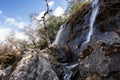 Wide double waterfall on rocky mountain slope in Nepal