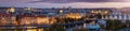Wide, elevated panorama of the lit skyline of Prague, Czech Republic