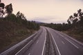 Wide empty highway with curve in the morning. Travel and destination background. Free asphalt road with mountain background. Royalty Free Stock Photo