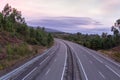 Wide empty highway with curve in the morning. Travel and destination background. Free asphalt road with mountain background. Royalty Free Stock Photo